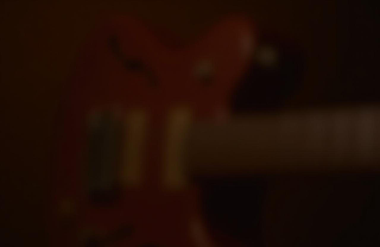 Close up of guitar strings and fingers